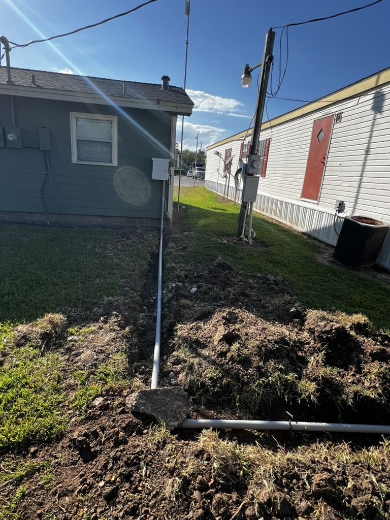 New underground conduit route crossing between buildings at an RV park.