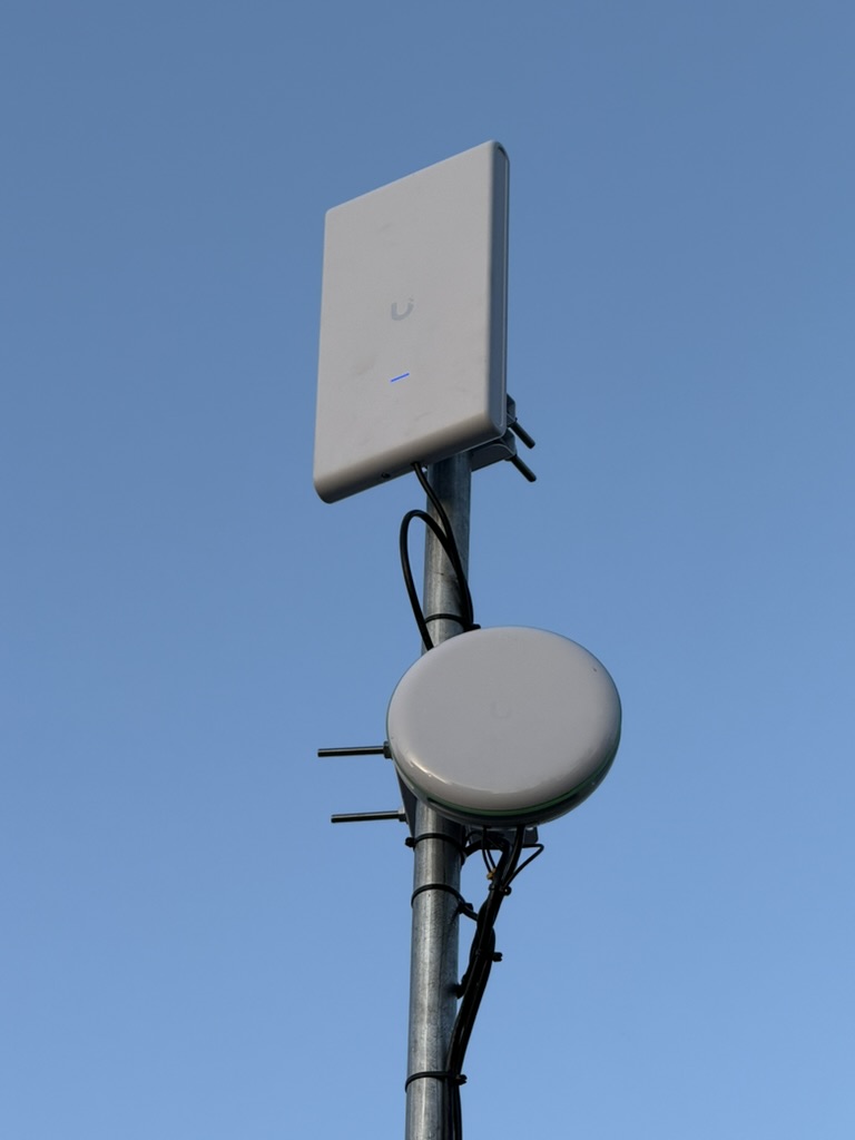 Pole-mounted wireless equipment installed for a network backhaul link.